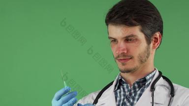 男性医疗工人持有注射器绿色背景